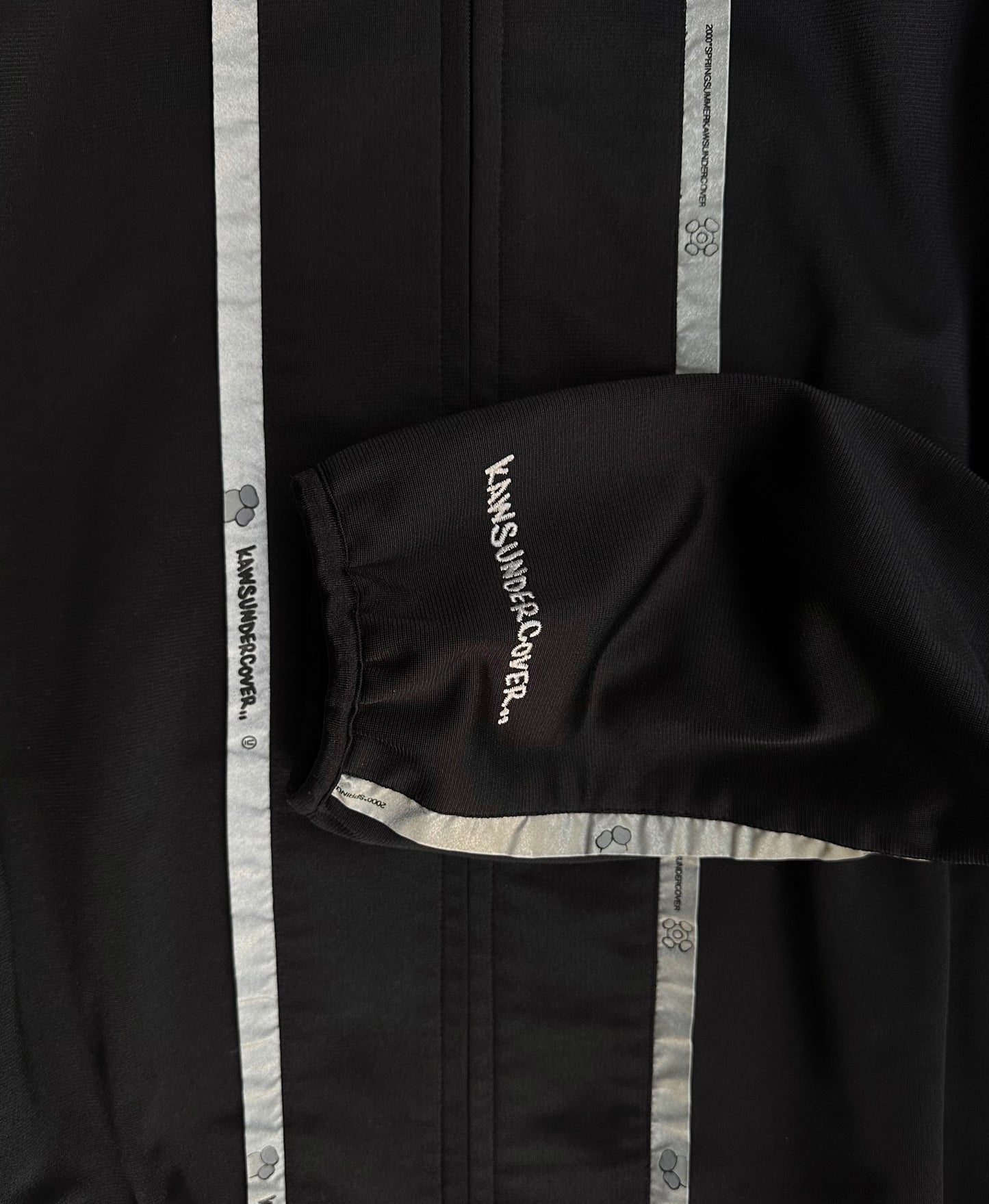 UNDERCOVER x KAWS SS00 Reflective Track Bomber Jacket