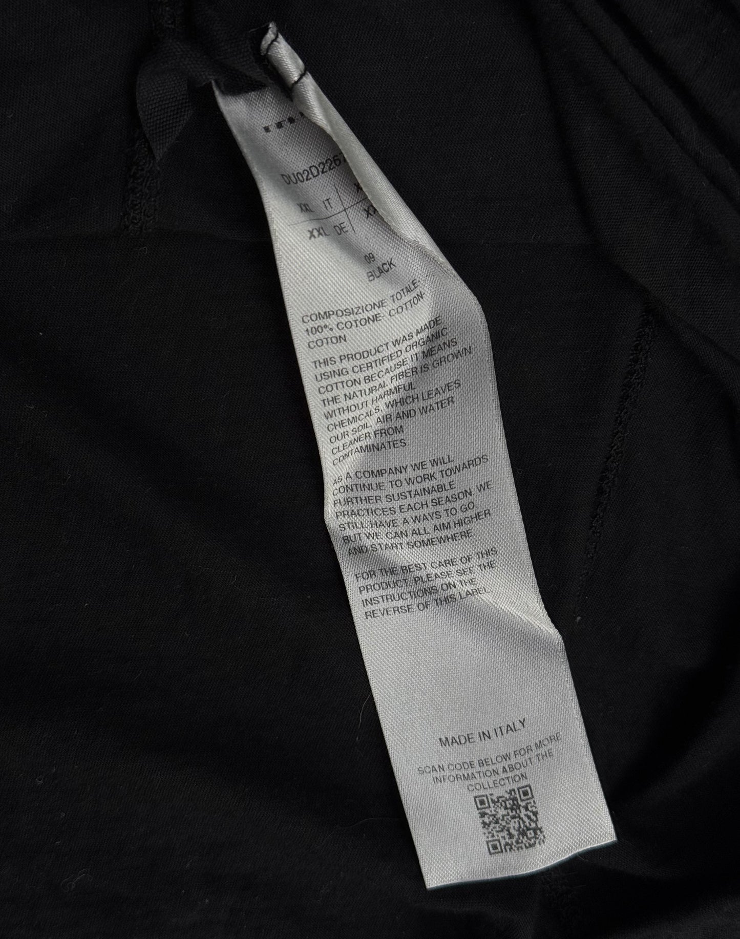 A close-up of a gray care label on Rick Owens DRKSHDW AW24 “PORTERVILLE” Geometric Level Long-sleeves shows washing instructions, material details, a QR code, and Made in Italy, showcasing the brands signature style.