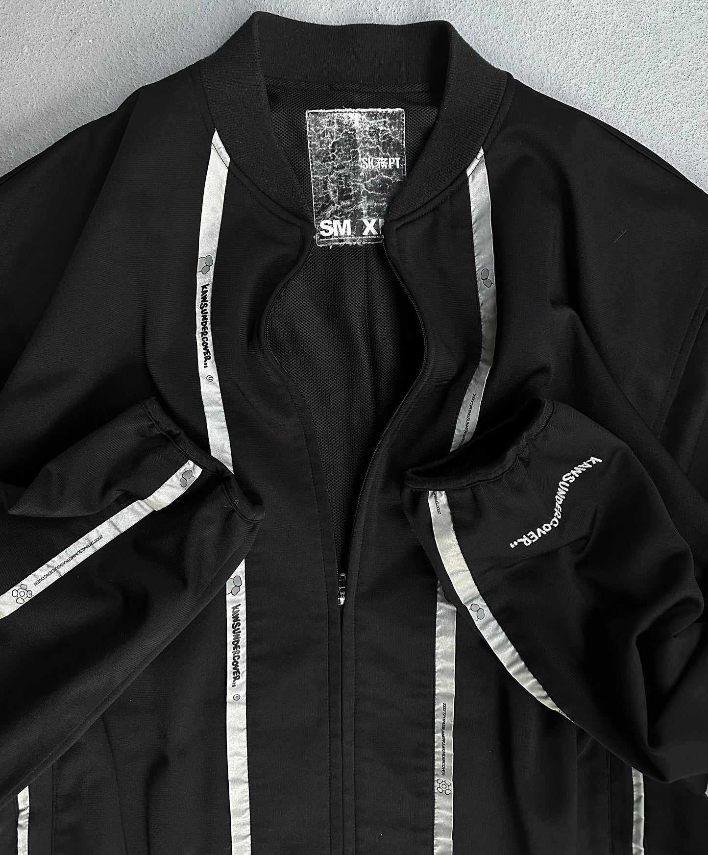 UNDERCOVER x KAWS SS00 Reflective Track Bomber Jacket