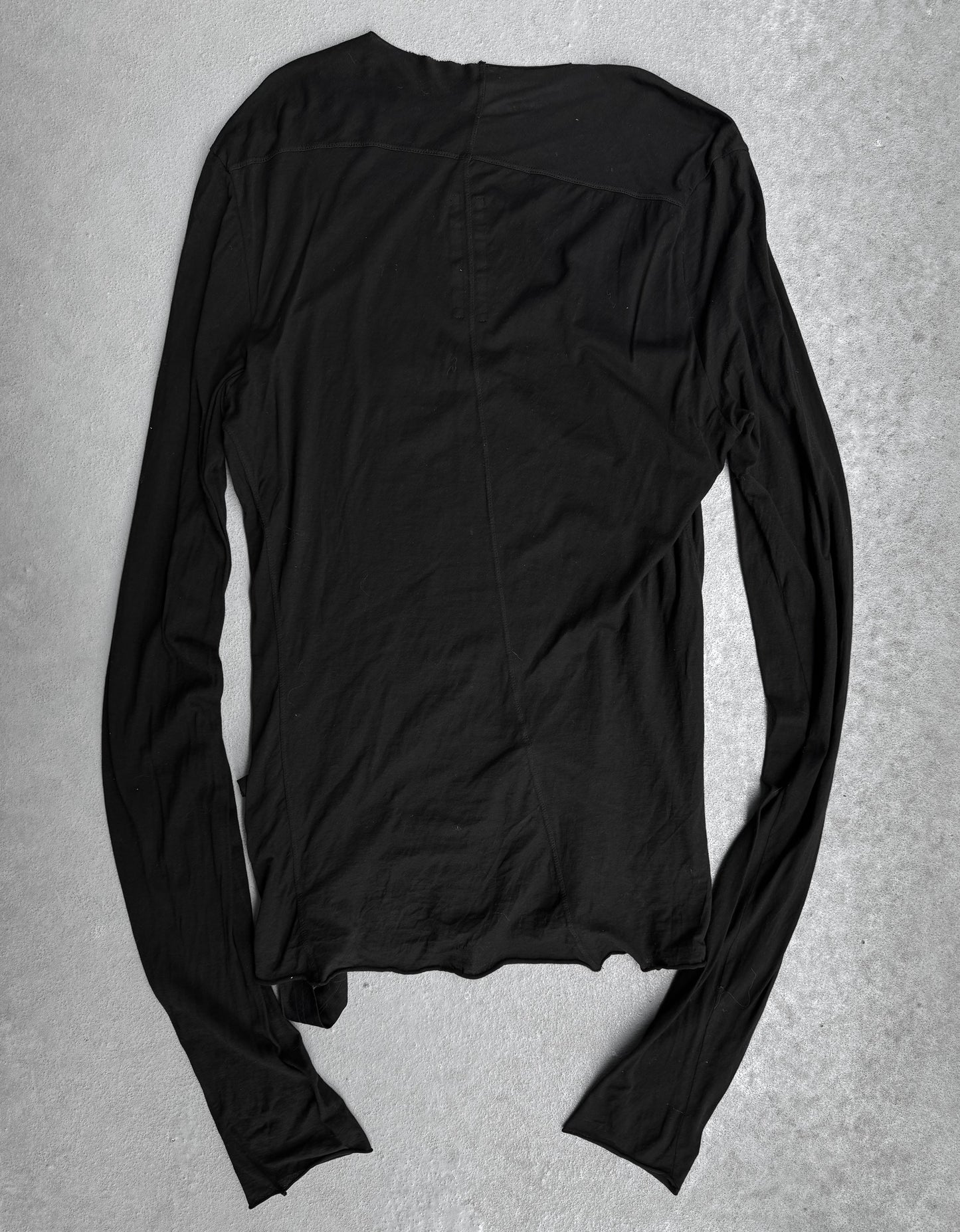 The Rick Owens DRKSHDW AW24 “PORTERVILLE” Geometric Level Long-sleeve shirt in black, featuring lightweight fabric and a contemporary design, is laid flat with its back facing up on a light gray textured surface.