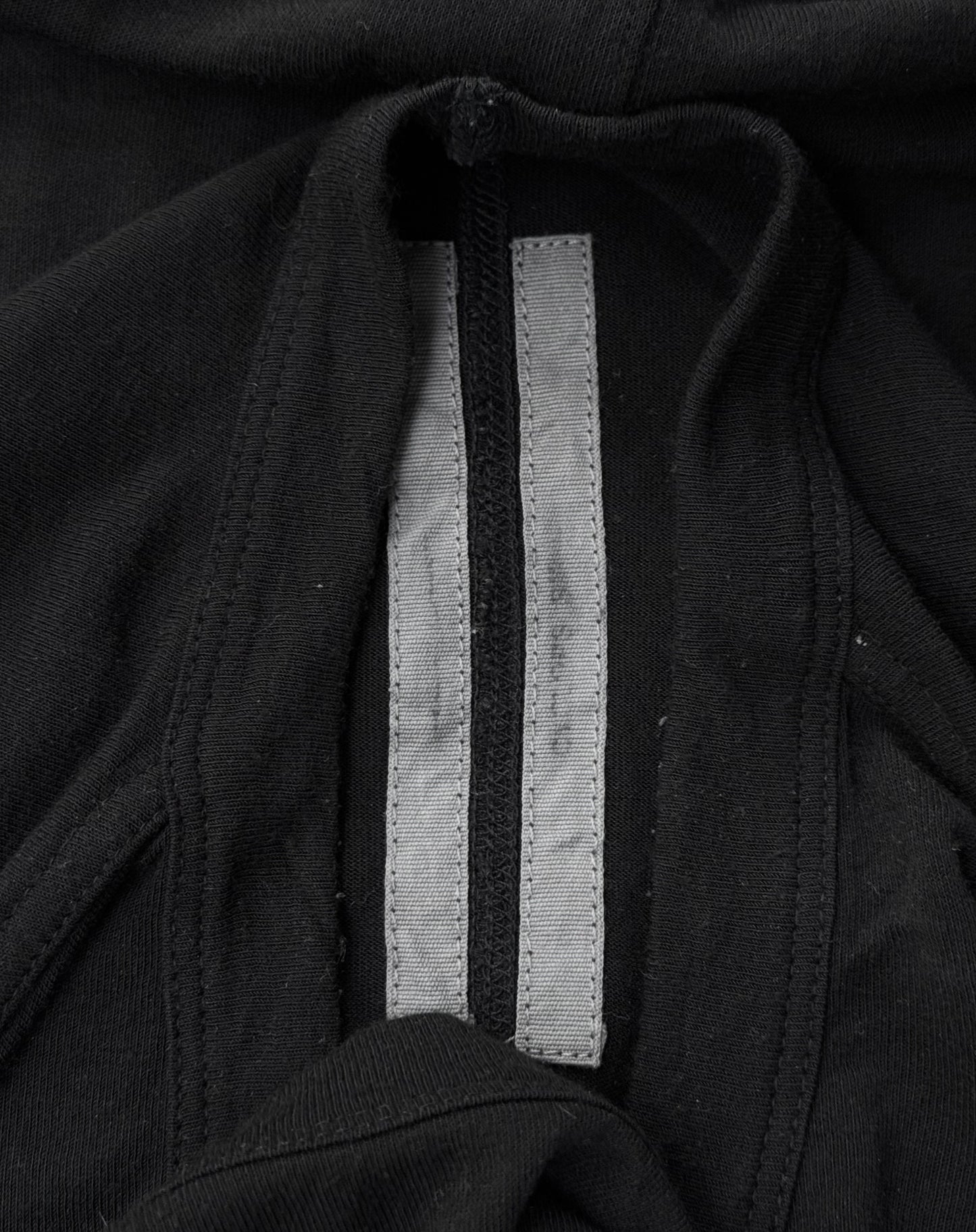 Close-up of a Rick Owens SS16 “CYCLOPS” Black Silk-blend Sheer Long-sleeve in Size XL, showing a gray fabric strip sewn into the inside seam, likely for reinforcement. Condition: 9/10.