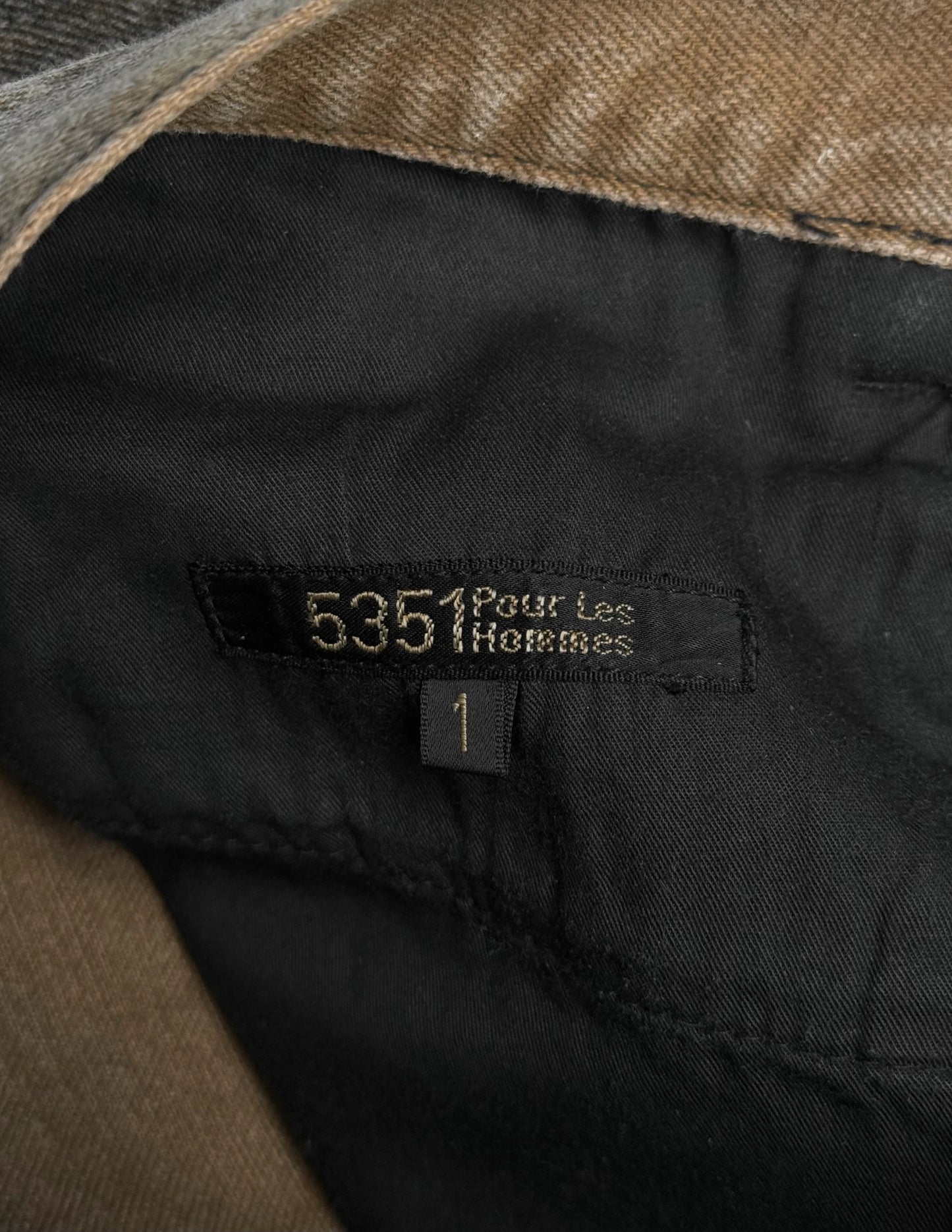 Close-up of a label on a piece of clothing with '5351 Pour Les Hermes' text.