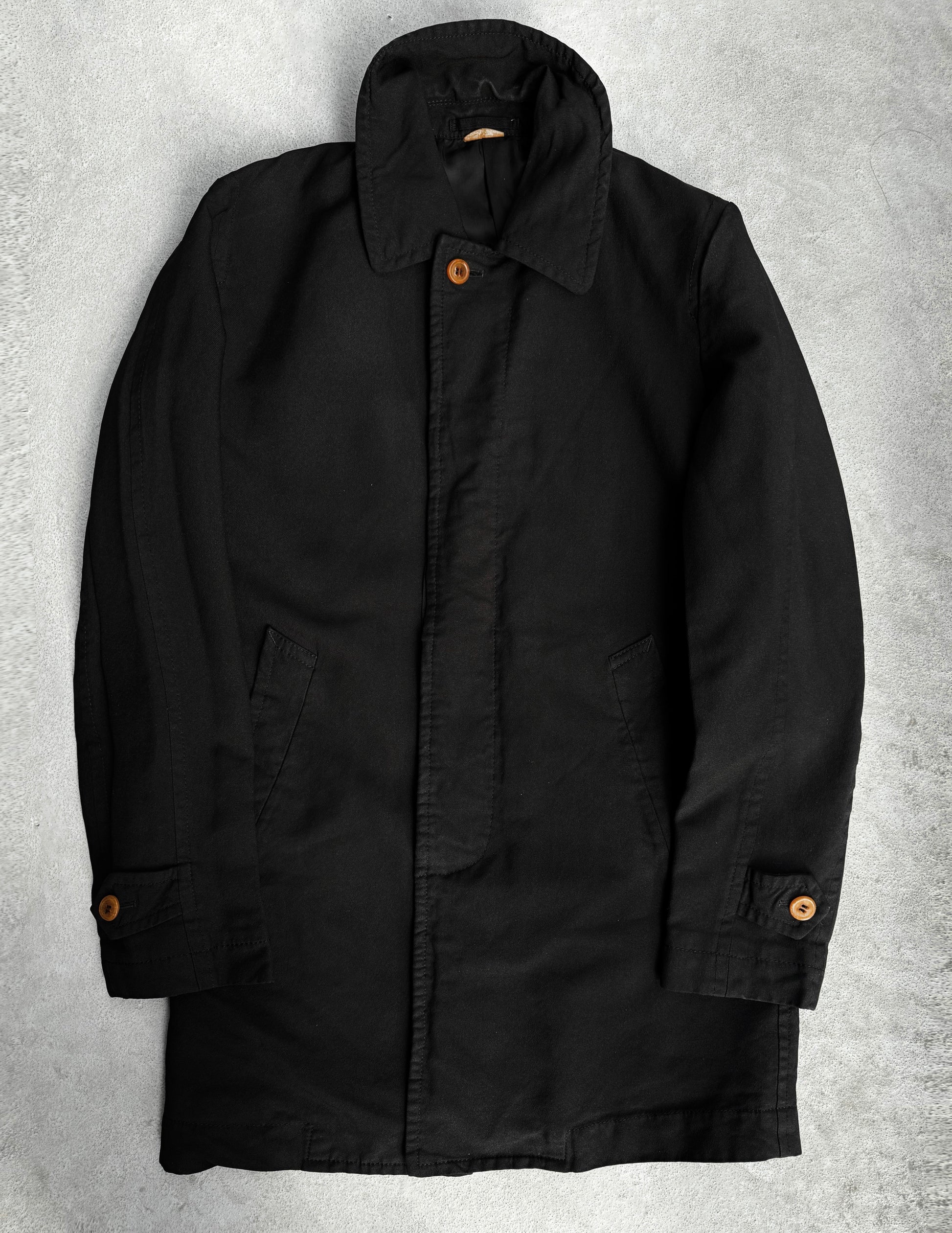 The COMME des GARÇONS HOMME DEUX Early 00s Reversible Button-up Coat, featuring wooden buttons and a high collar, showcases avant-garde fashion with its menswear-inspired side pockets and buttoned cuffs. It lays flat on a light gray surface.