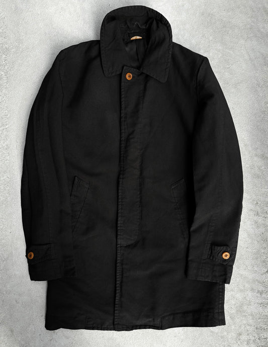 The COMME des GARÇONS HOMME DEUX Early 00s Reversible Button-up Coat, featuring wooden buttons and a high collar, showcases avant-garde fashion with its menswear-inspired side pockets and buttoned cuffs. It lays flat on a light gray surface.