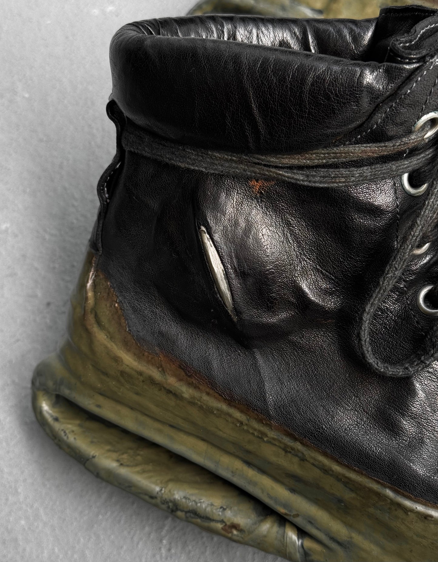 A close-up of DRIEW Carol Christian Poell ‘AM/2685P ROOMS-PTC/12’ object-dyed kangaroo leather titanium prosthetic U-sole drip sneakers, EU 41.5-42 (Size 6), with scuffs, cracks, discoloration, a visible tear near rust, and heavy wear.