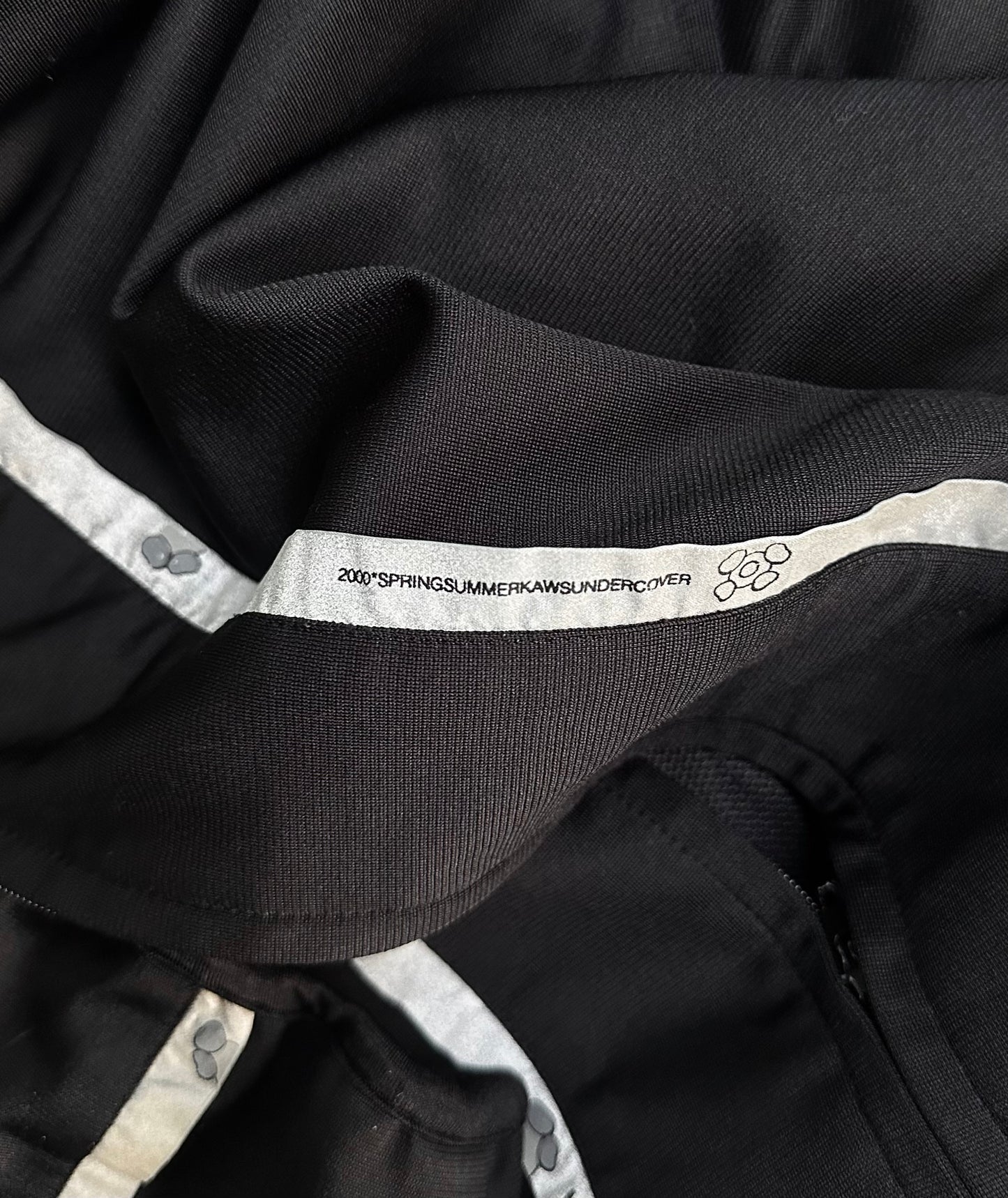 UNDERCOVER x KAWS SS00 Reflective Track Bomber Jacket