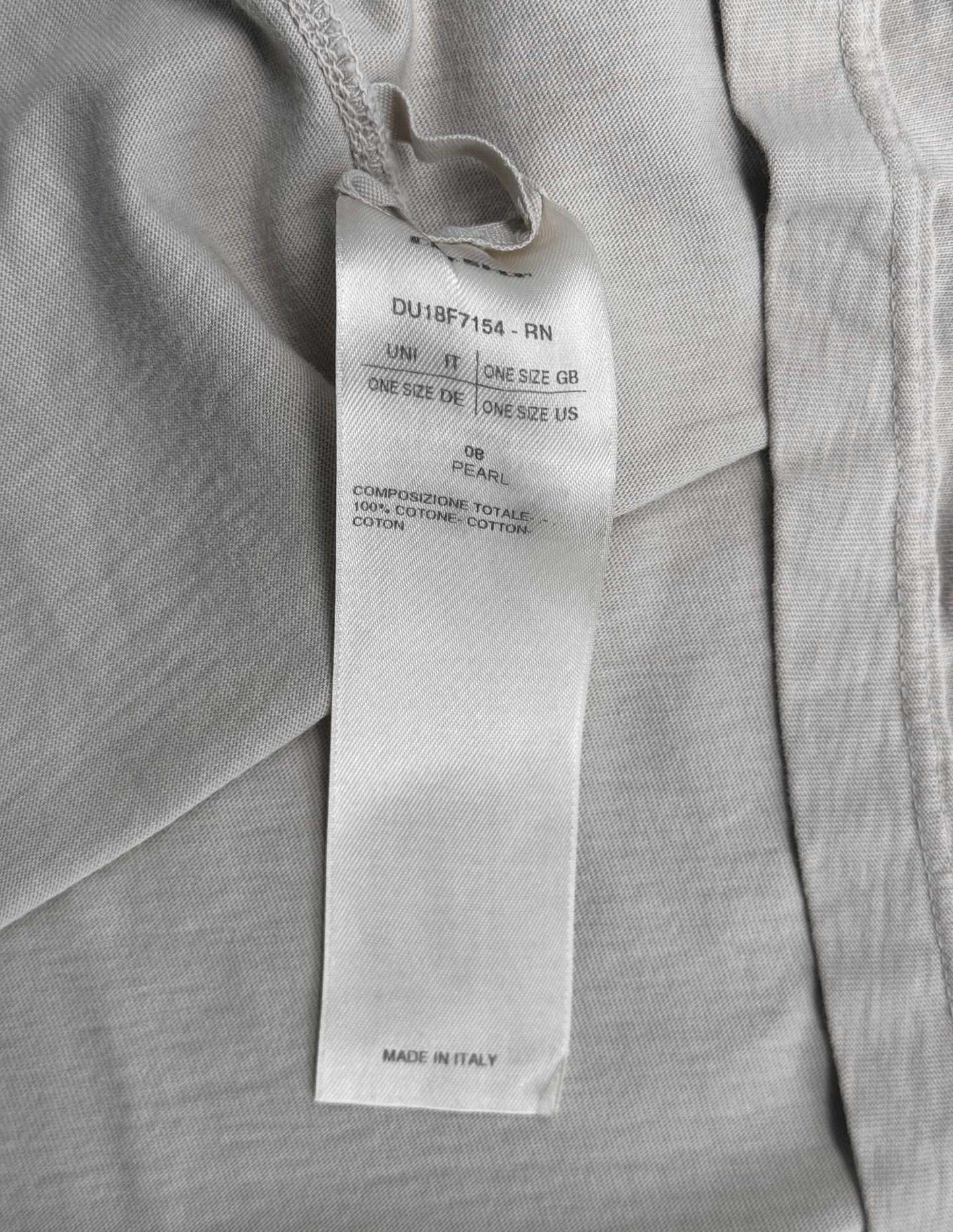 A white tag on light gray fabric from the Rick Owens DRKSHDW AW18 “SISYPHUS” Pearl Racer Tank Top shows one size for various regions, 100% cotton material, and indicates it was made in Italy.
