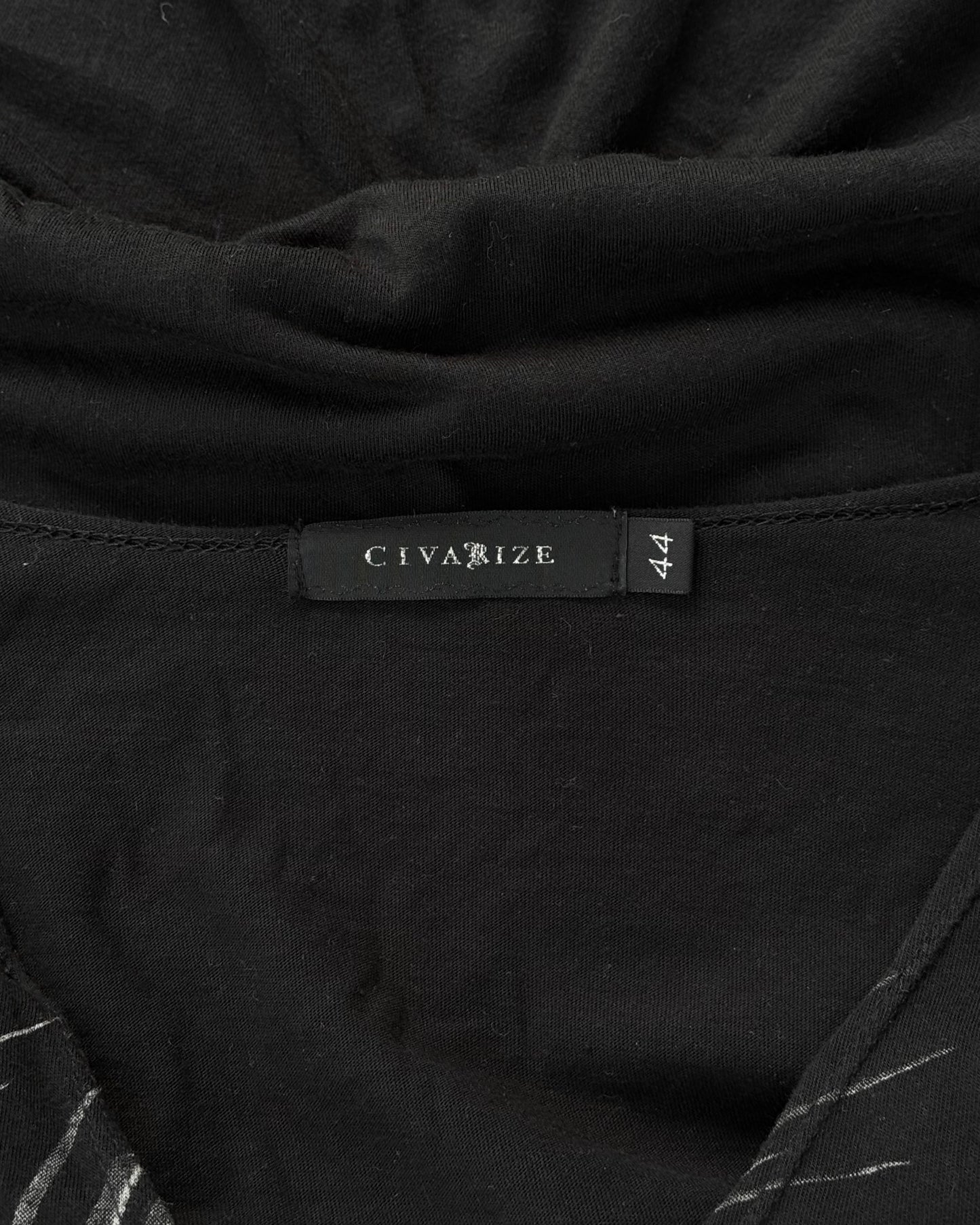 Close-up of a black CIVARIZE Early 00s Floral Skull Graphic Long Curve T-shirt, size 44. The fabric is slightly gathered above the tag, showcasing Visual Kei-inspired designs and alternative fashion aesthetics.