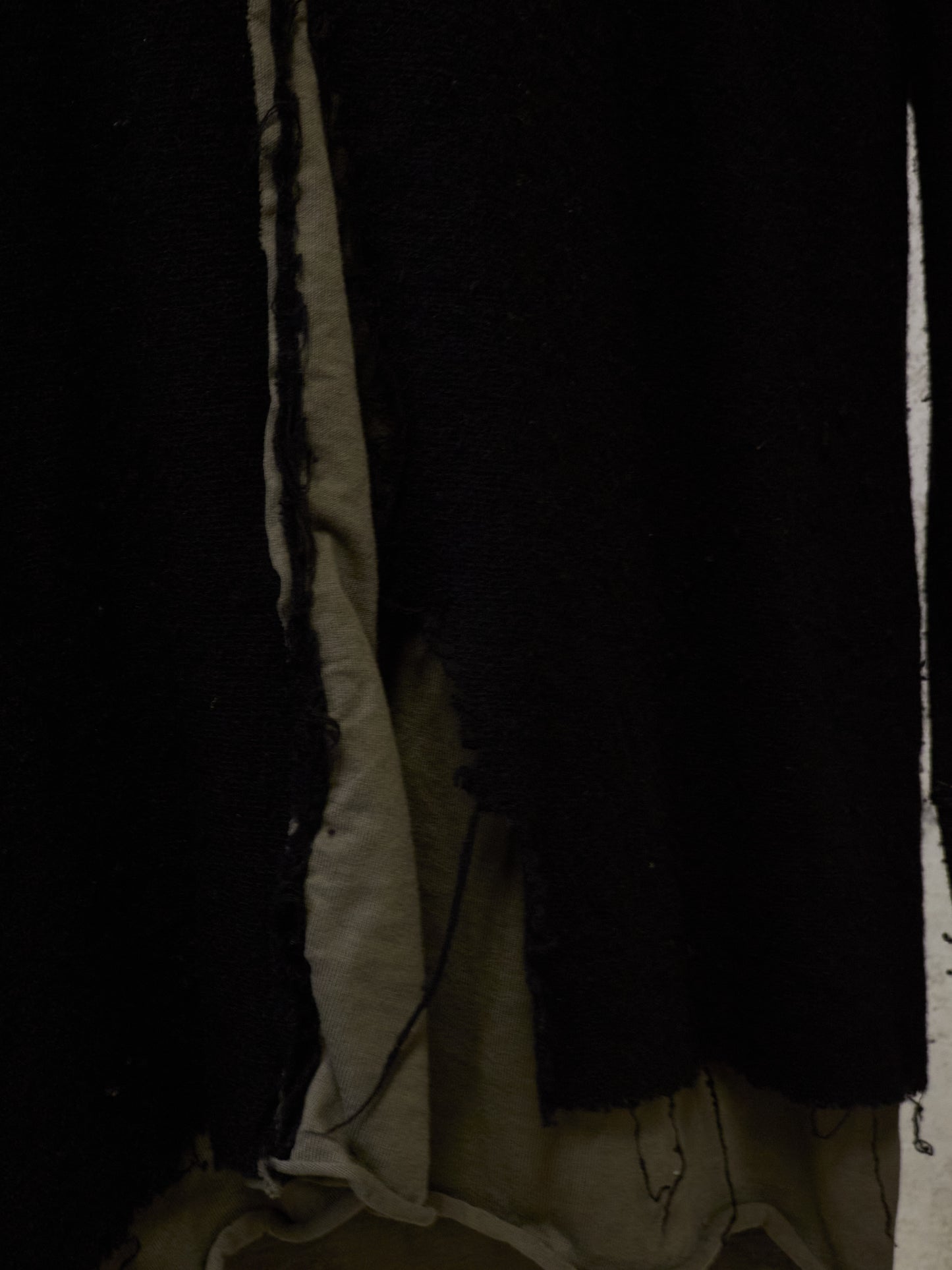 Dark and light fabric with visible texture and edges