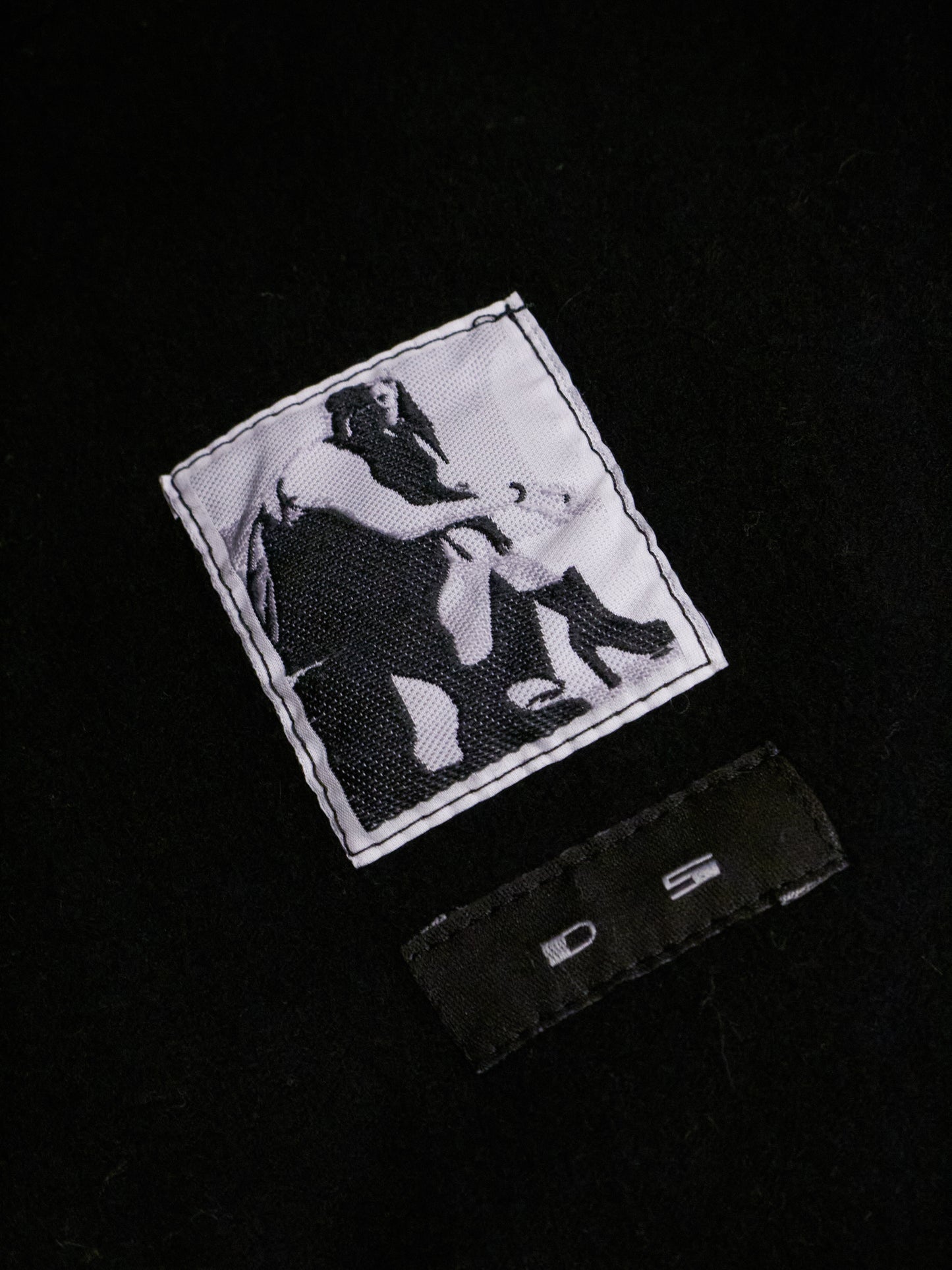 Black and white patch with graphic design on a black background