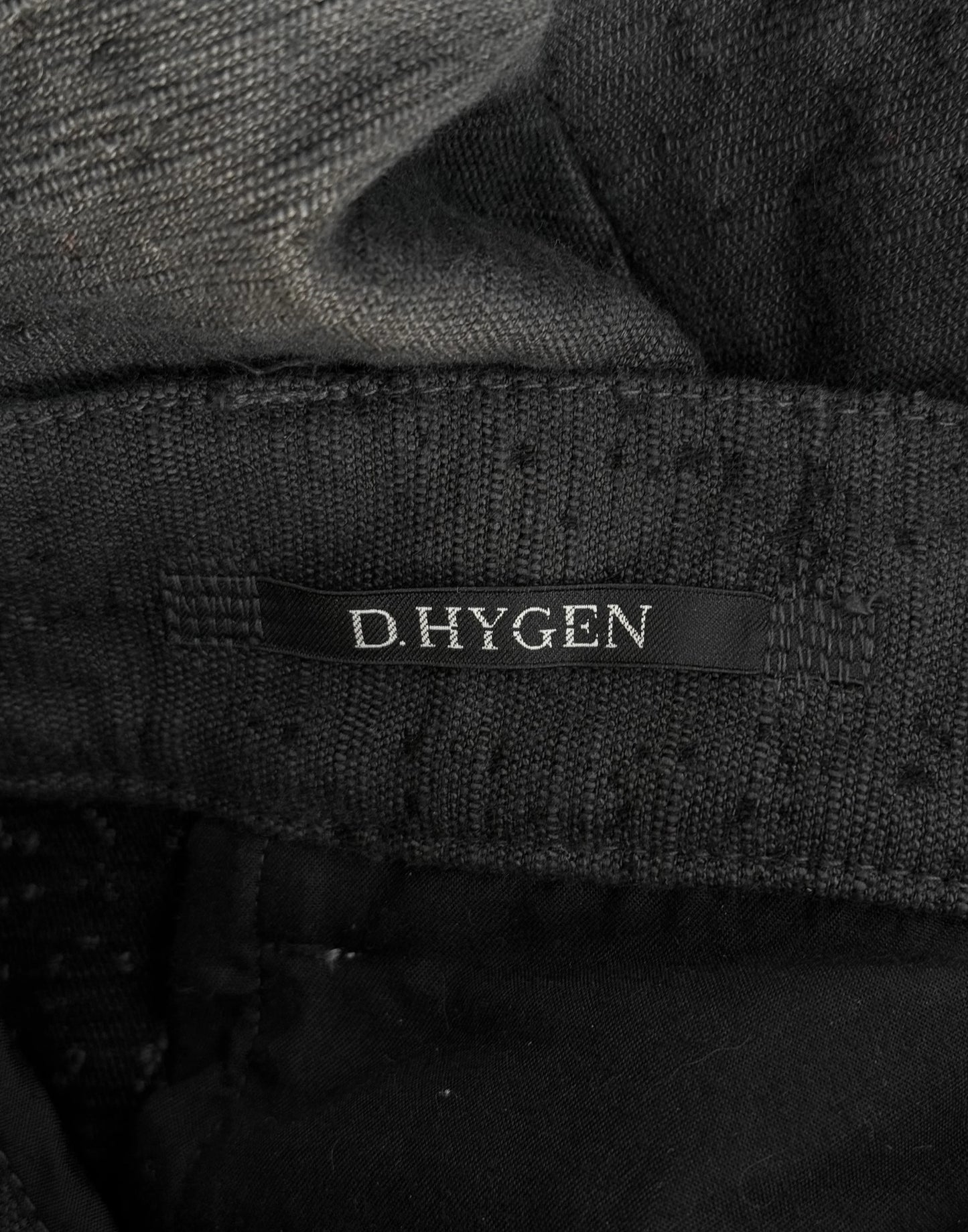 Close-up of a black fabric with 'D. Hygen' label