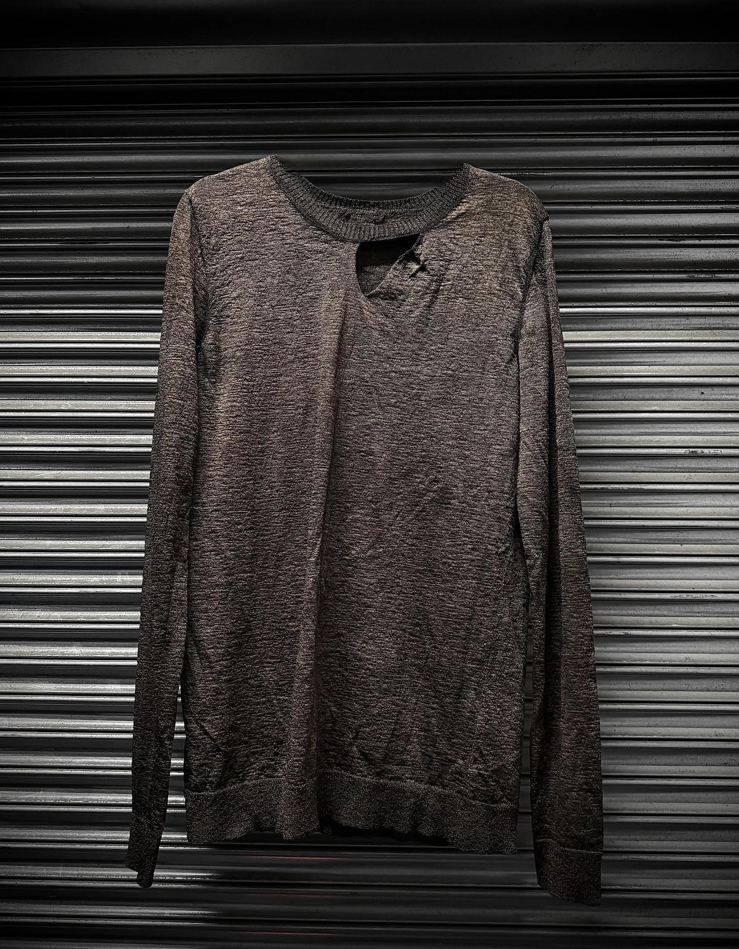 Brown sweatshirt on a metallic surface