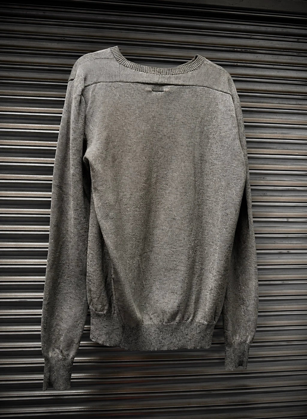 Gray sweater on a metallic surface