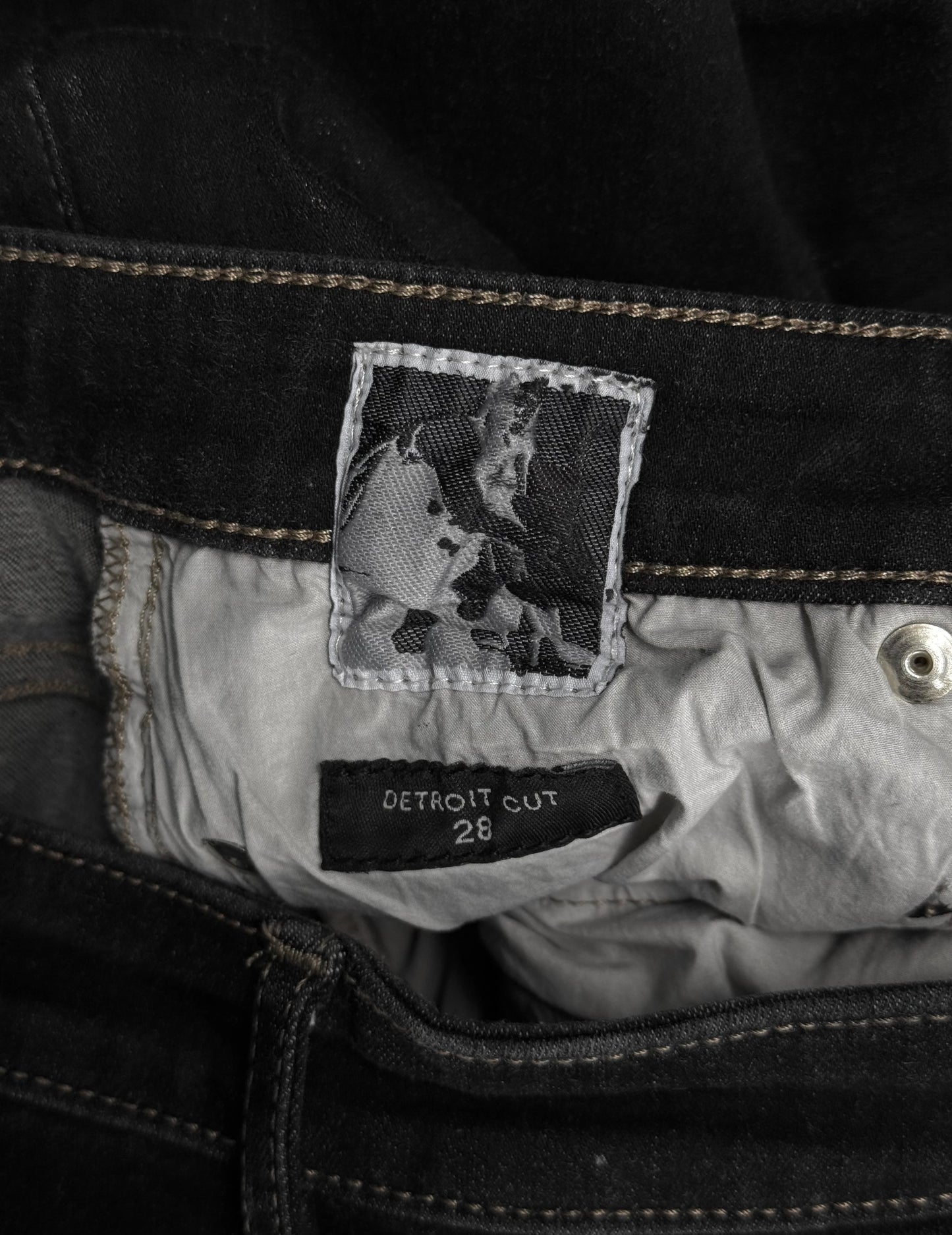 Close-up of a label on a jacket with a black and white photo and text.