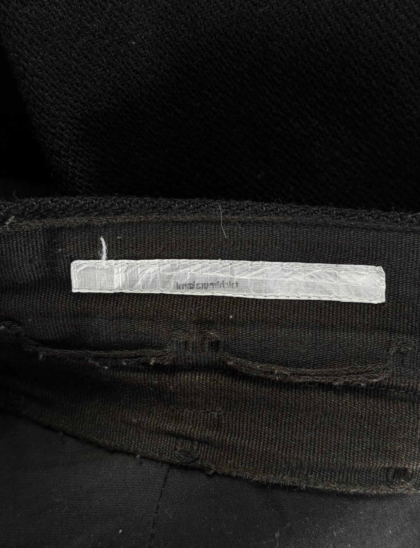 Black fabric with a white label on a dark background