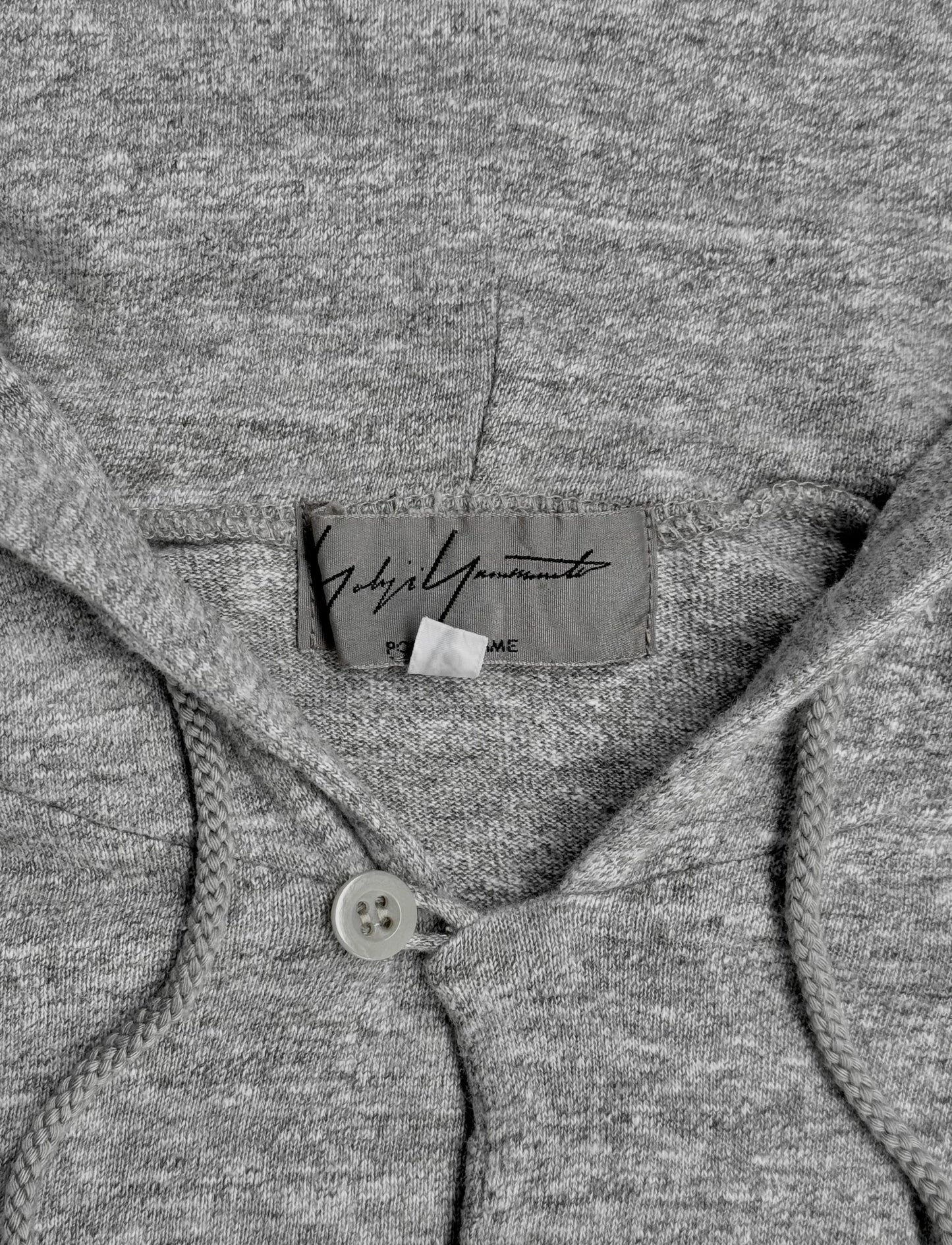Close-up of a gray garment with a brand label.