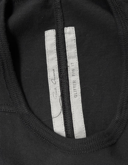 Close-up of a black Rick Owens AW17 “GLITTER” Level Short-sleeves T-shirt collar with two white inner tags—one reading GLITTER FW17 and the other with signature text. Size IT 40, flawless condition.