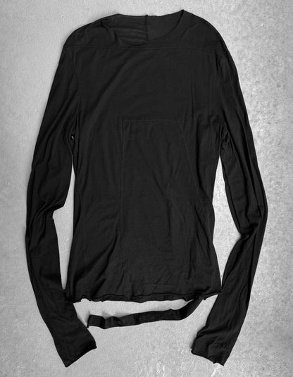 The Rick Owens DRKSHDW AW24 “PORTERVILLE” Geometric Level Long-sleeves features a loose fit, wide neckline, and attached cloth belt, all in black, reflecting minimalist Rick Owens style on a light gray textured background.