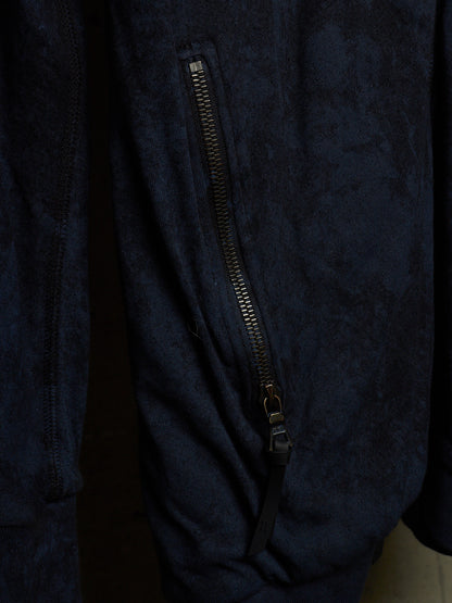 Close-up of a dark navy textured jacket with a vertical black zipper detail.