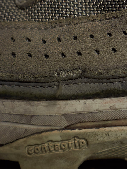 Close-up of the side of a Contagrip shoe showing a worn, frayed, and damaged section of the midsole and suede upper.