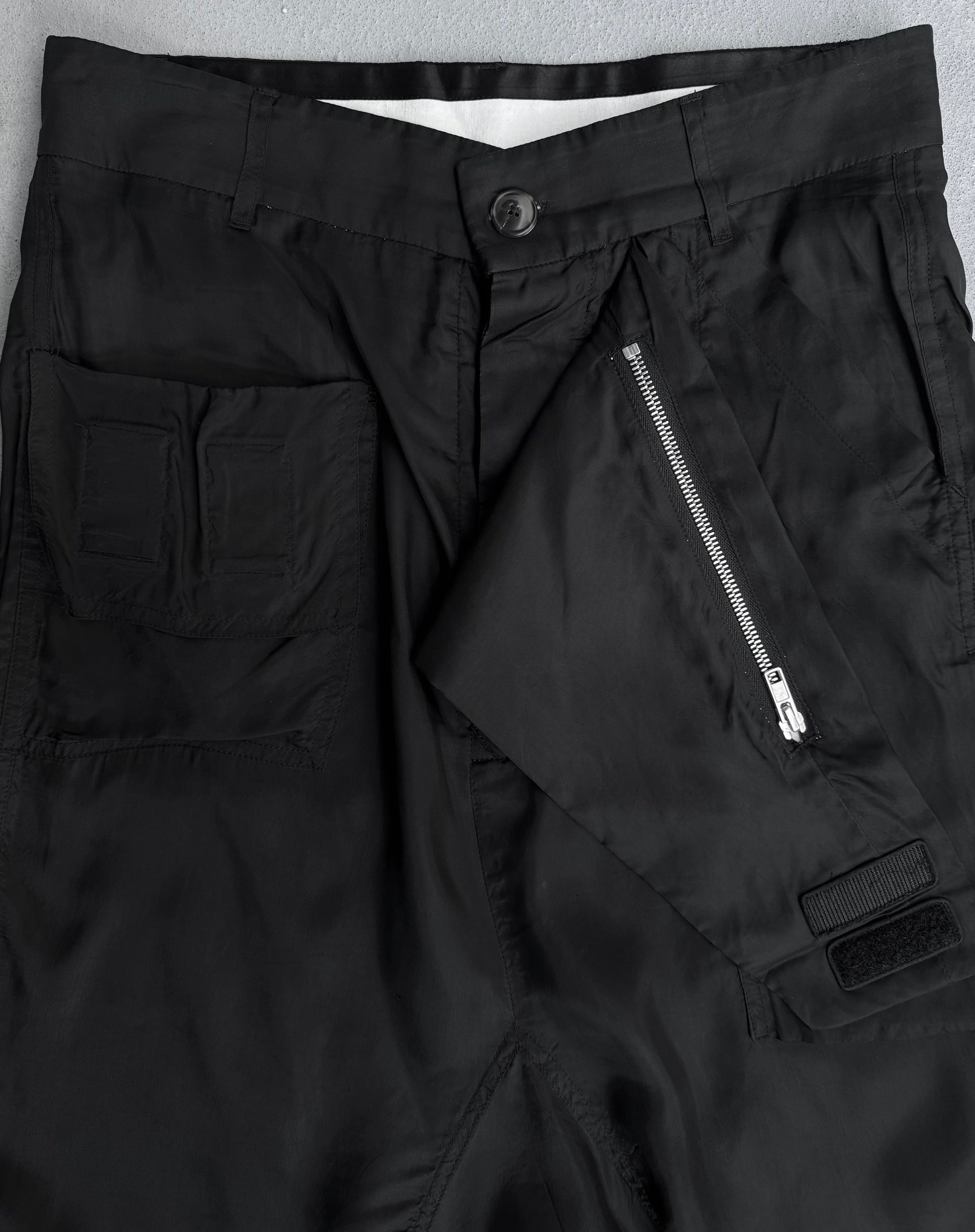 Close-up of Rick Owens SS14 “VICIOUS” Lightweight Memphis Shorts in black, size US 28-29 (IT40), featuring a front zipper partially open, buttoned waistband, and left pocket with two stitched sections. Fabric is lightweight and smooth.
