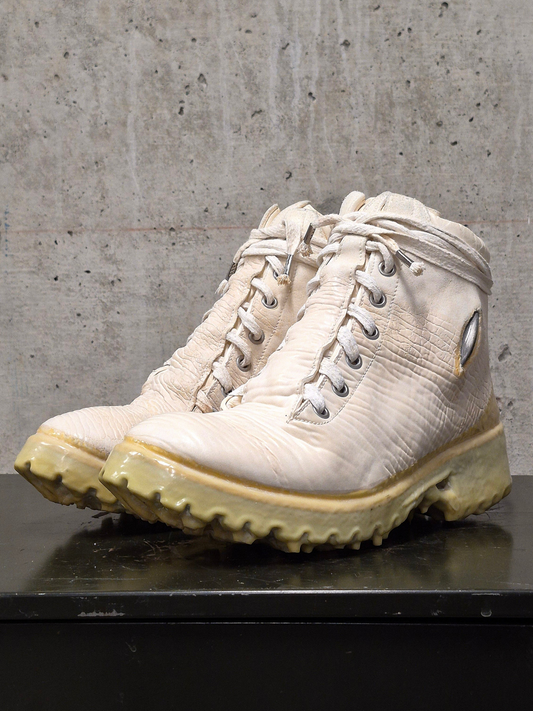 Pair of beige hiking boots on a concrete surface