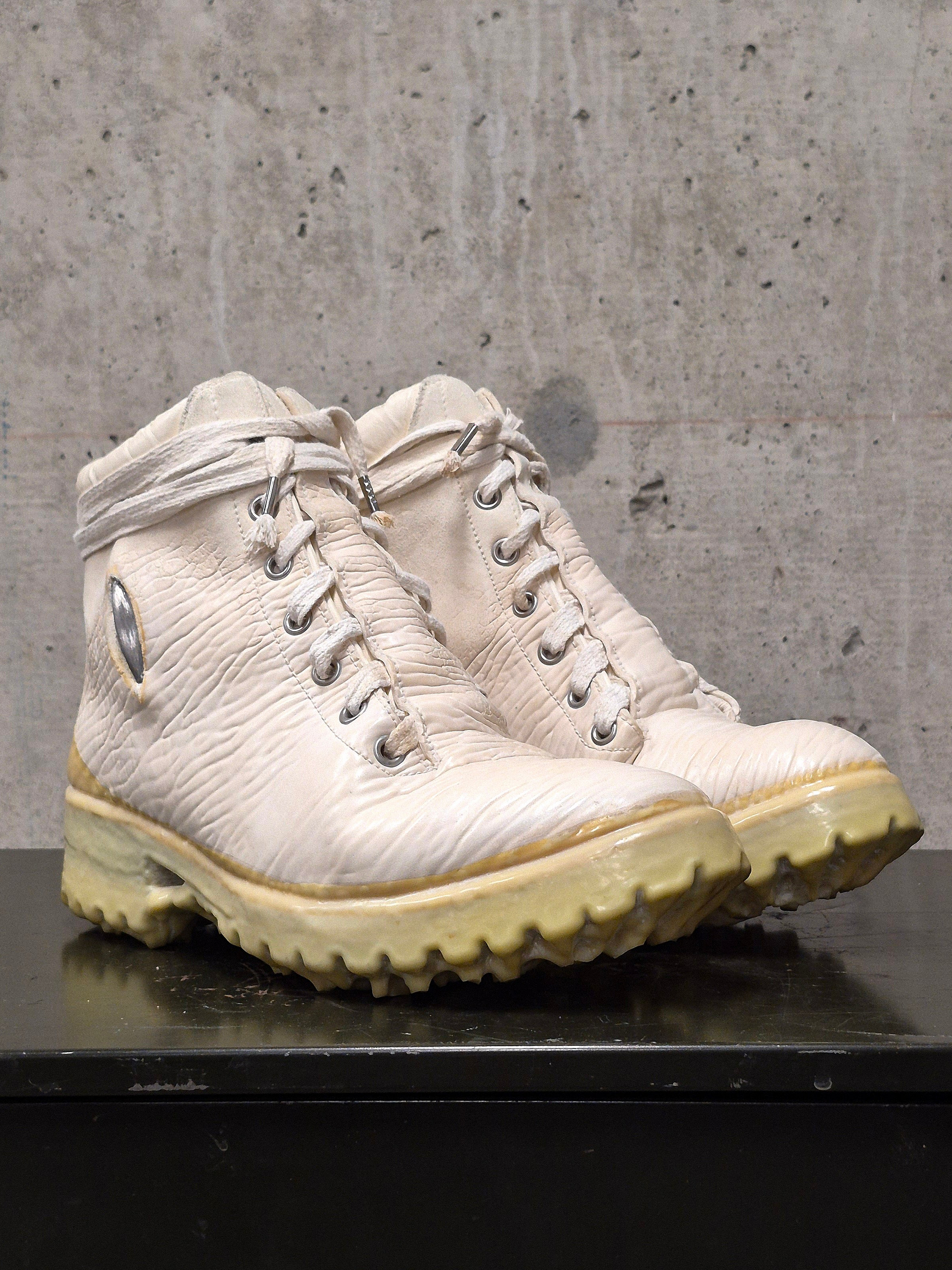 Pair of beige hiking boots on a concrete surface