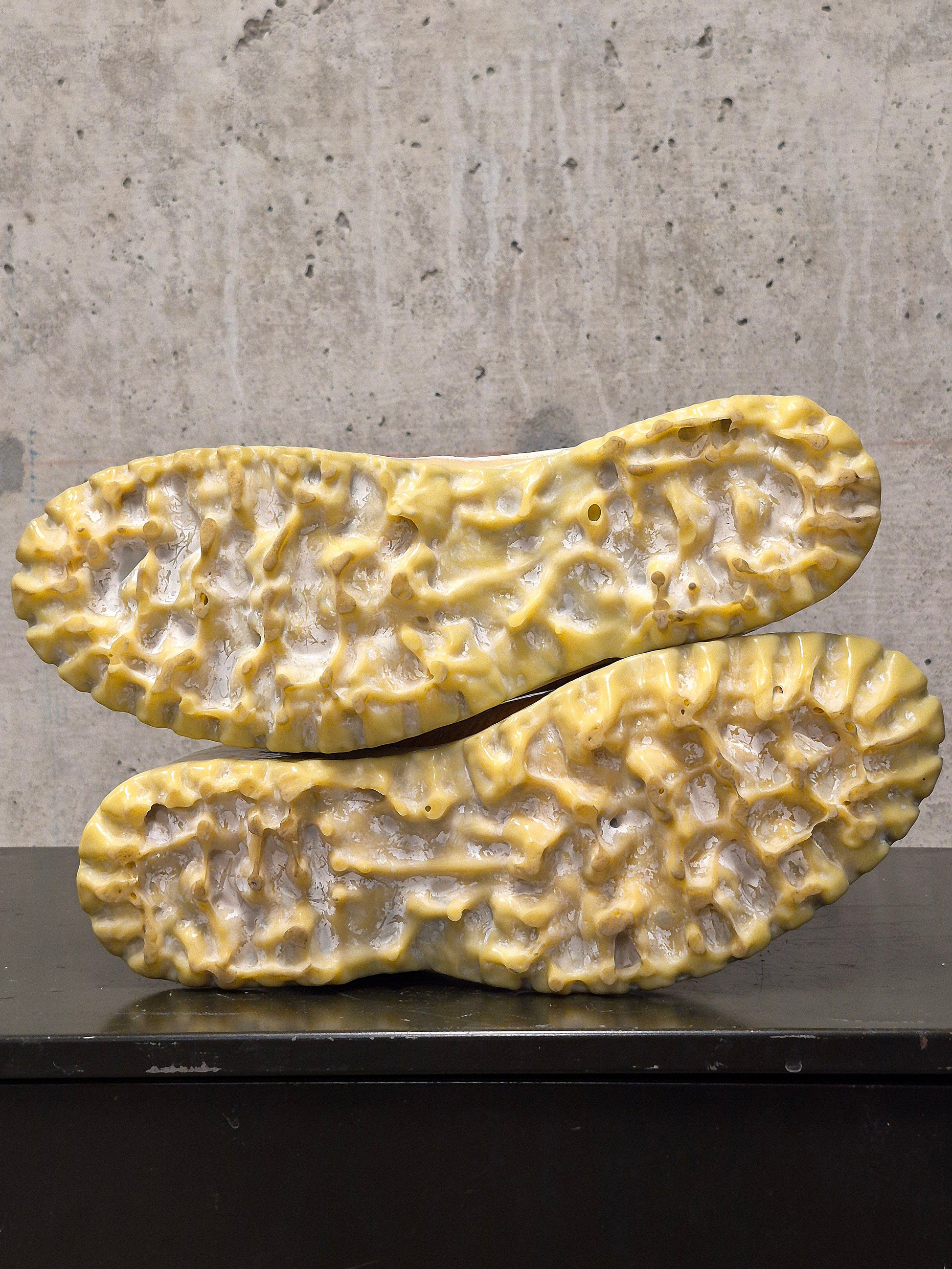 Yellowed sole of a shoe on a concrete surface