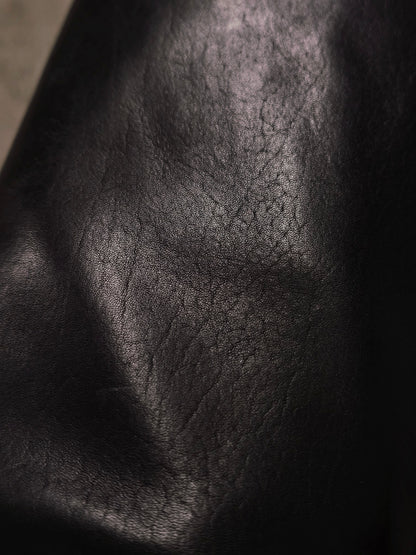 Close-up of a textured black leather surface
