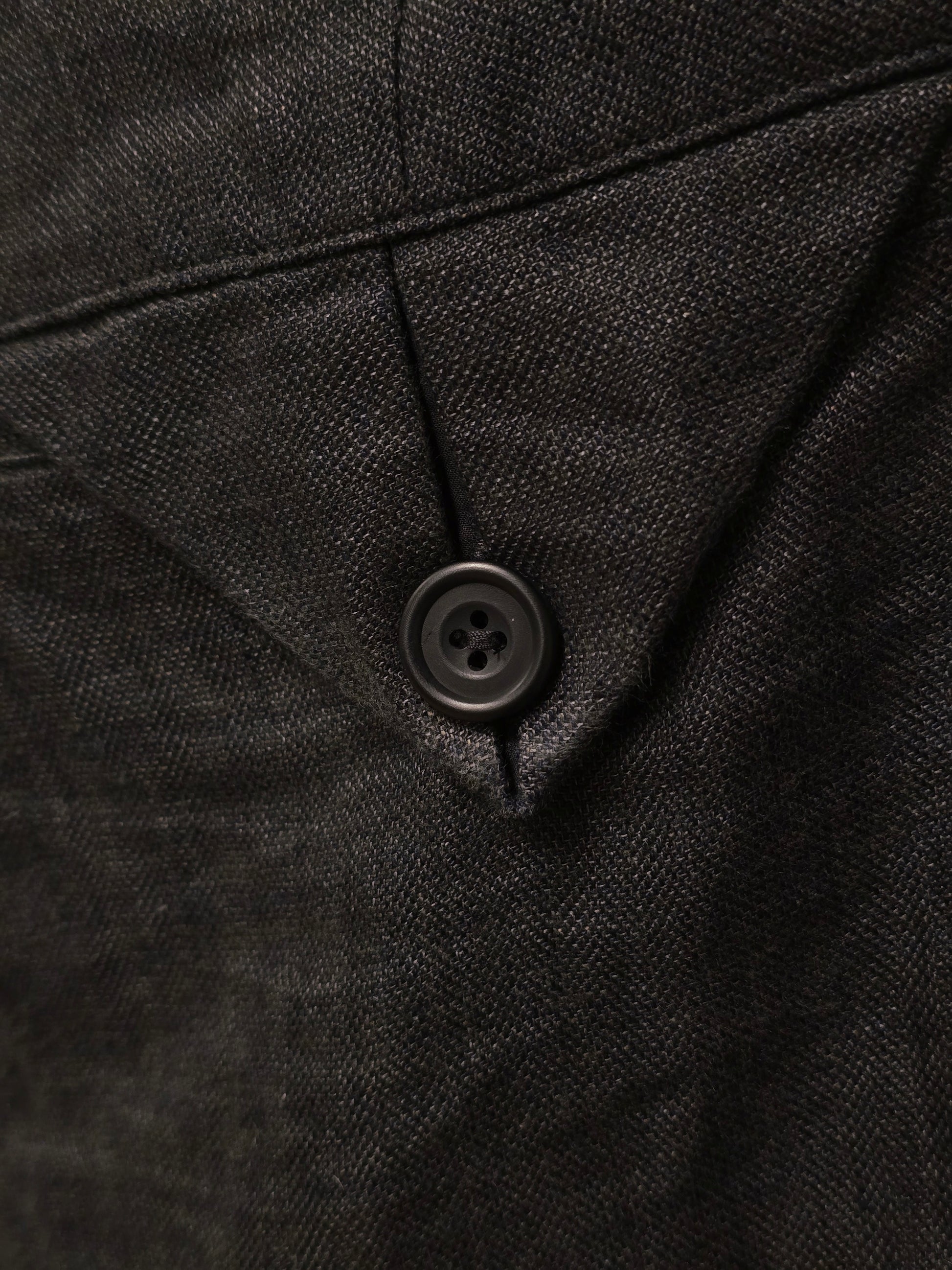 Close-up of a black textured fabric with a button