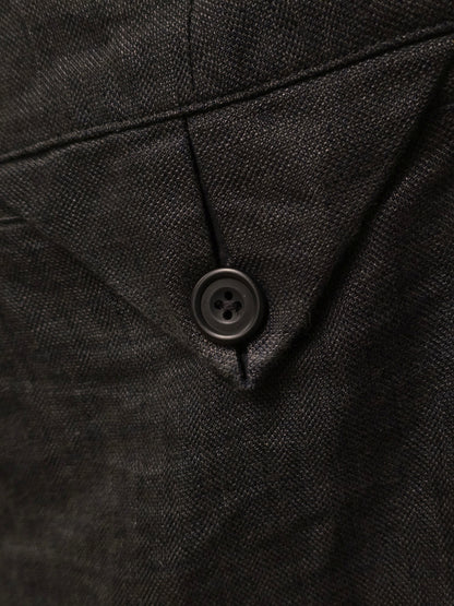 Close-up of a black textured fabric with a button