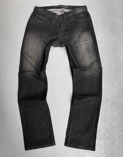 The Surface To Air SS14 Faded Black Bootcut Skinny Denim by Surface To Air lays flat, legs extended and waistband open—a modern staple for contemporary menswear and urban style.