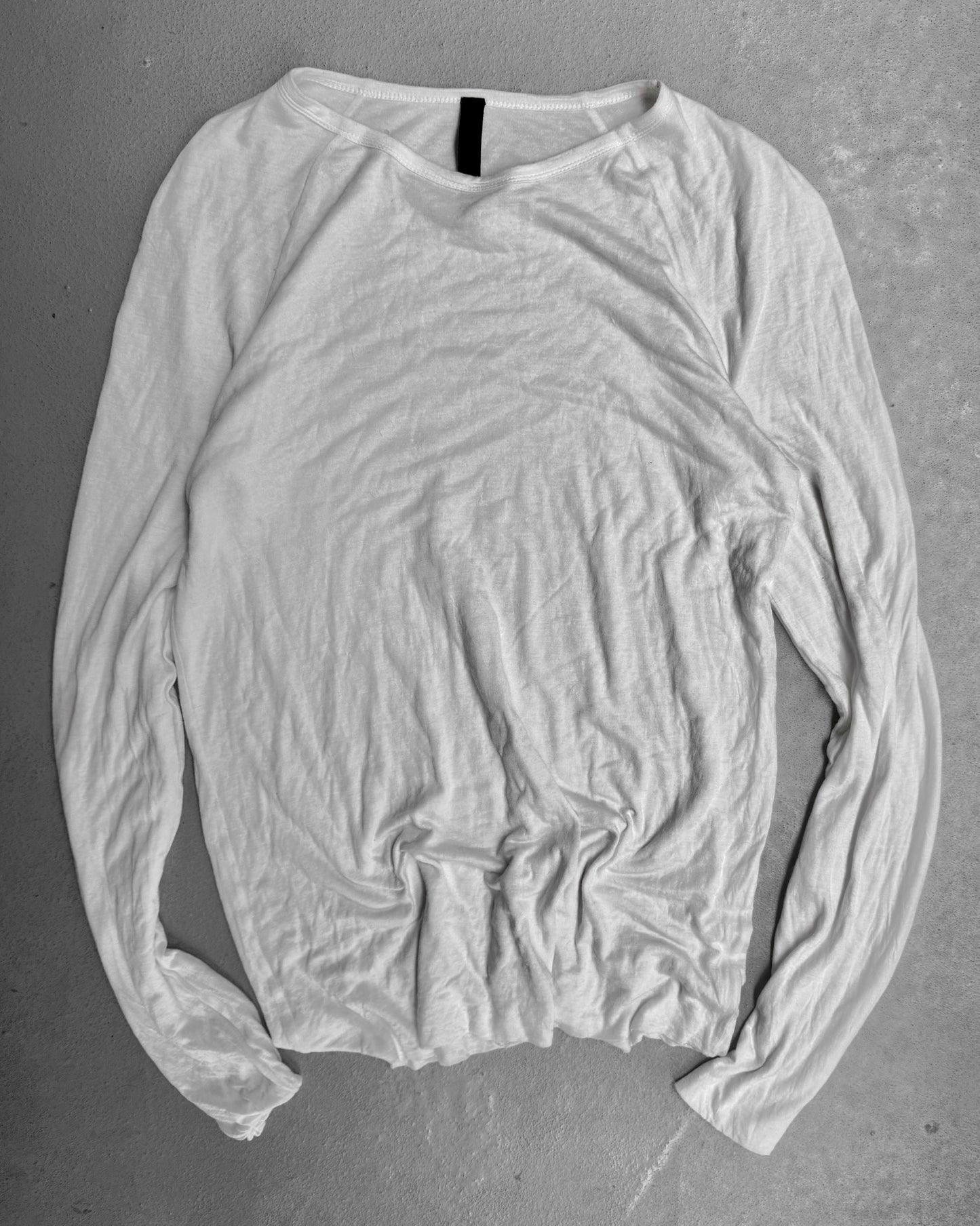 Ripped white long-sleeve shirt on a gray background