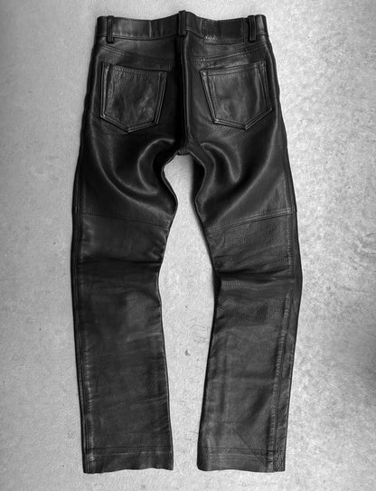 Black leather pants on a gray textured background