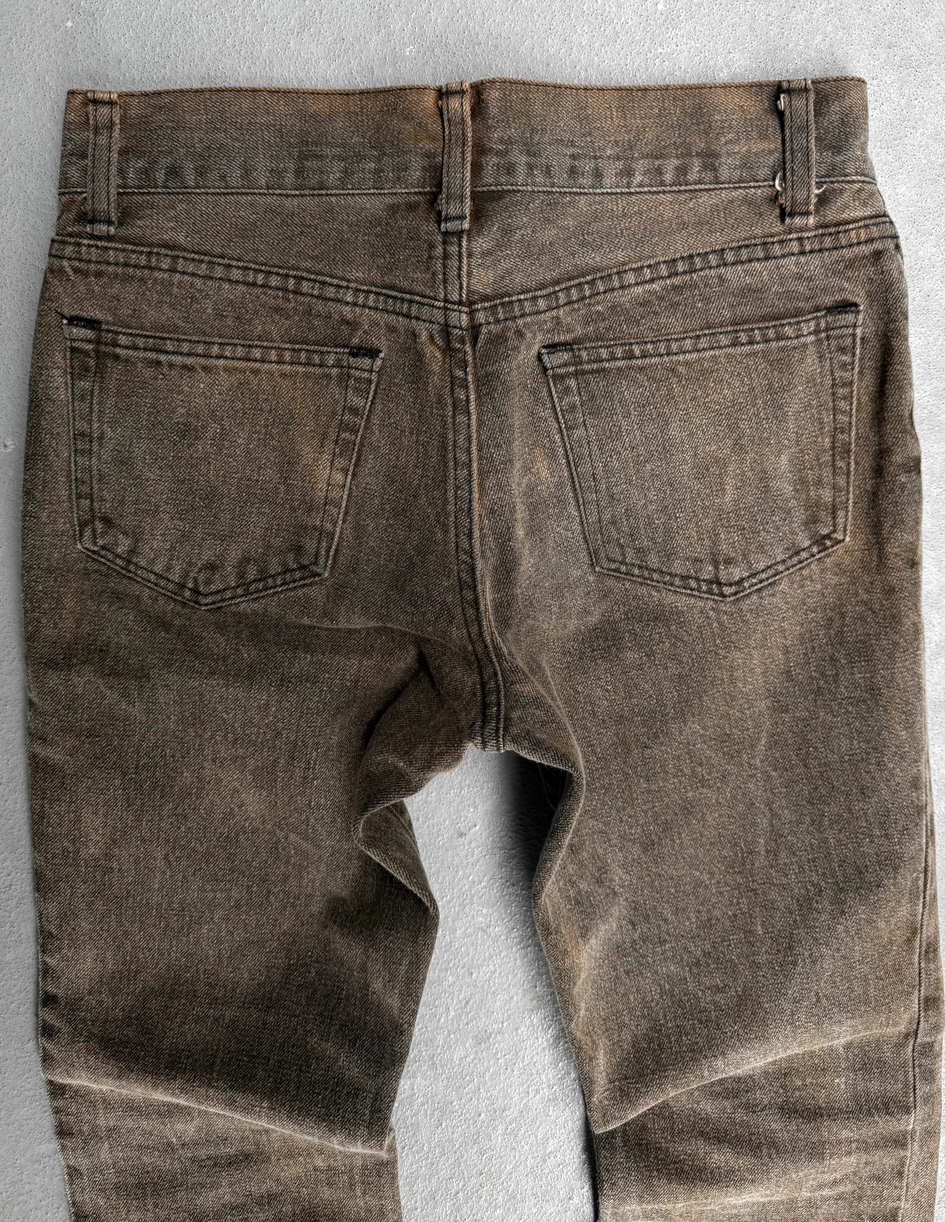 Brown denim jeans on a gray background