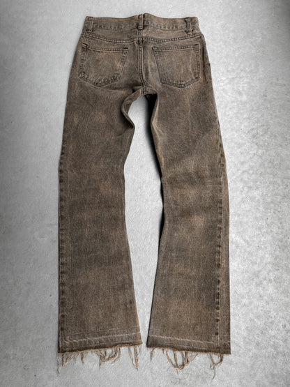 Brown distressed jeans on a gray background