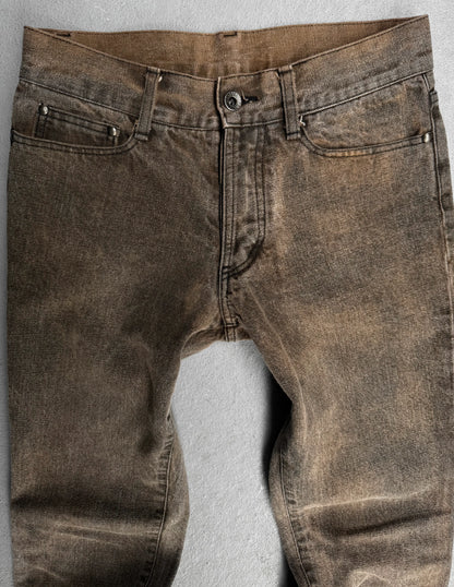 Brown distressed jeans on a light gray background
