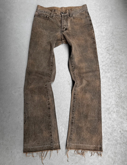 Brown distressed jeans on a gray textured background