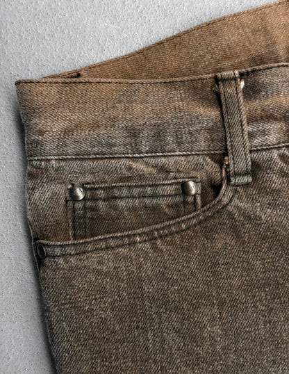 Close-up of brown denim jeans on a gray background