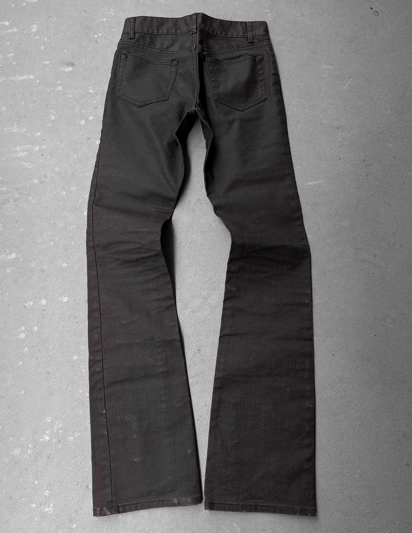 Dark gray pants on a textured gray surface