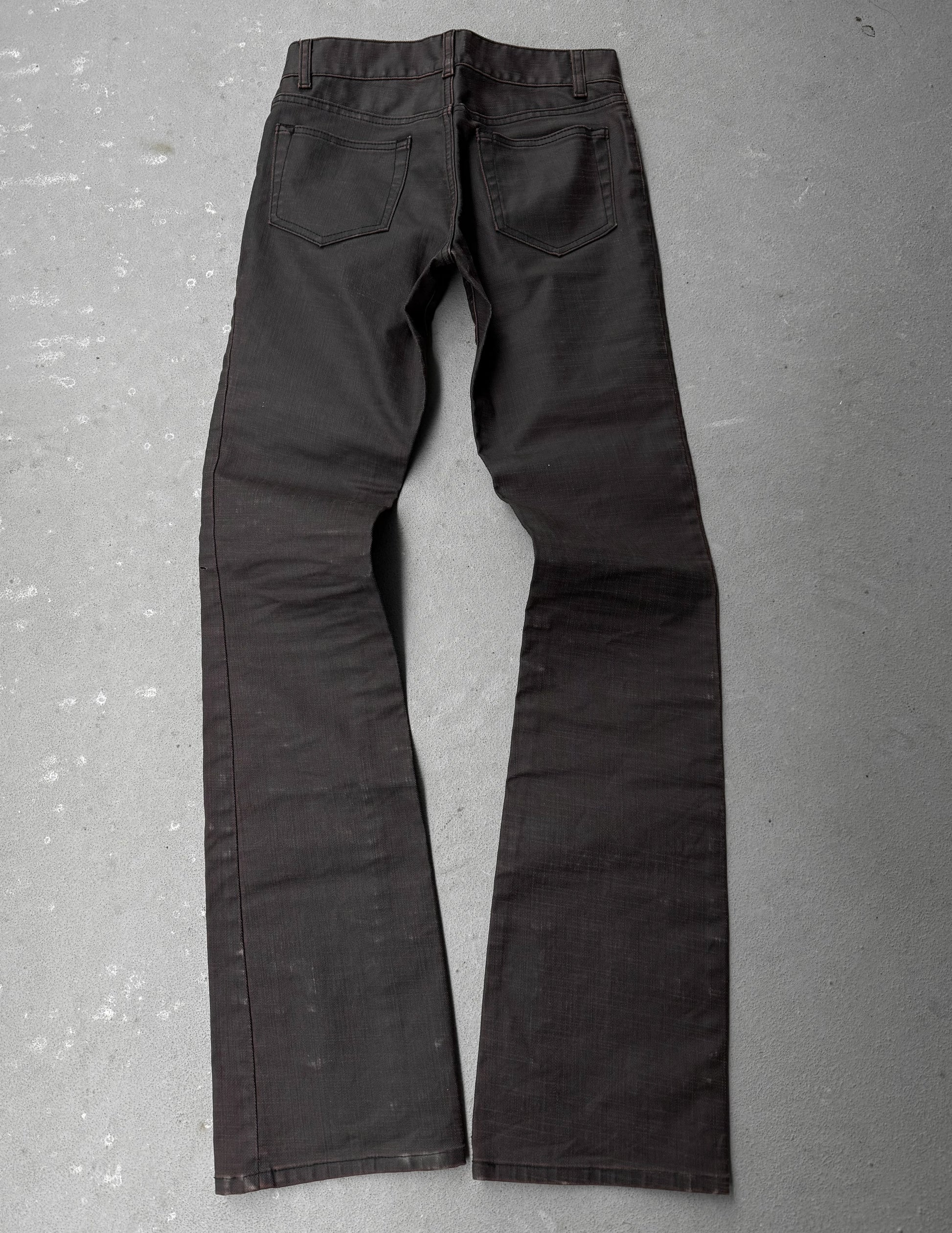 Dark gray pants on a textured gray surface