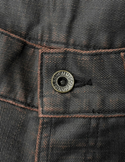 Close-up of a button on a dark denim jacket