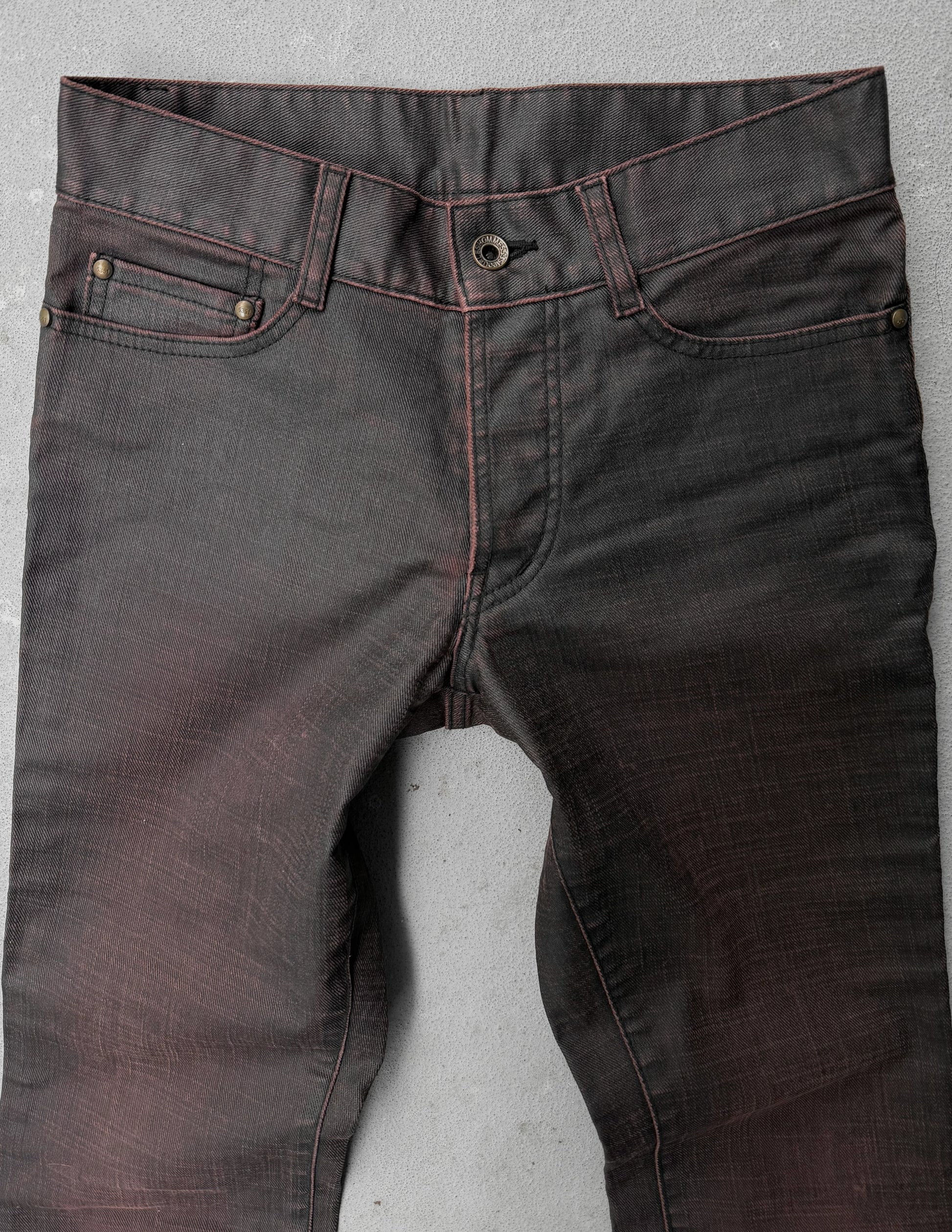 Dark gray jeans on a light gray background