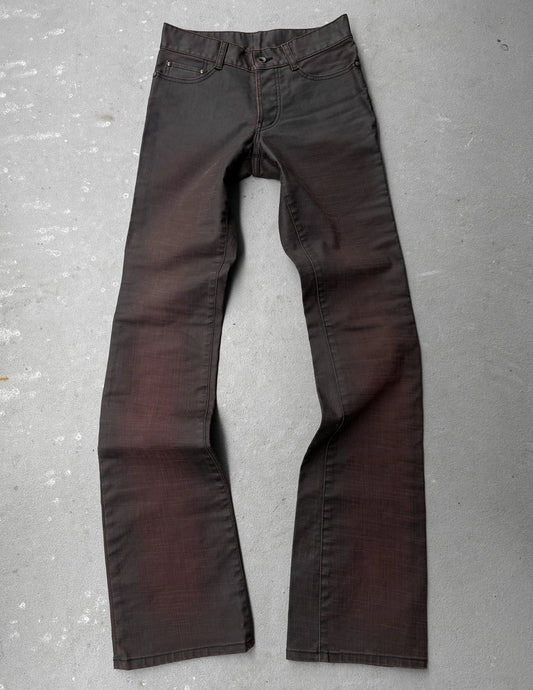 Dark brown pants on a gray concrete surface