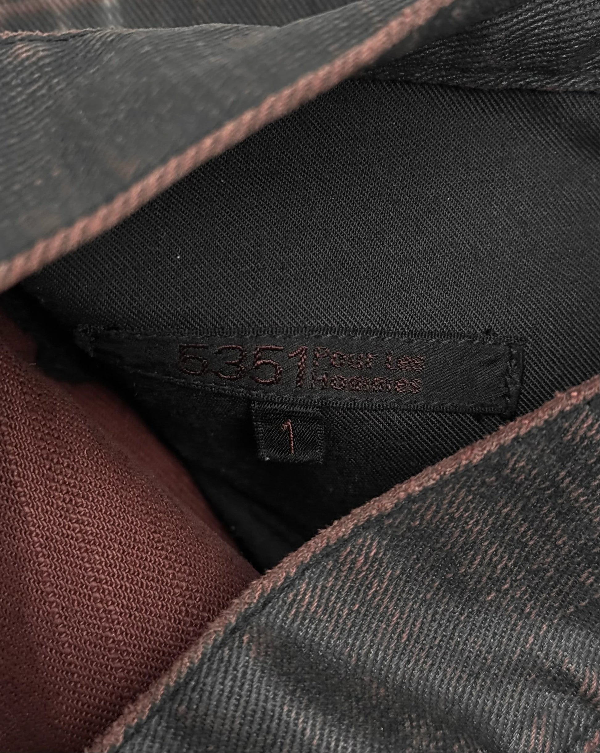 Close-up of a clothing label on a textured fabric background