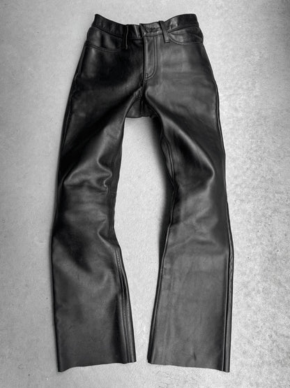 Black leather pants on a gray background