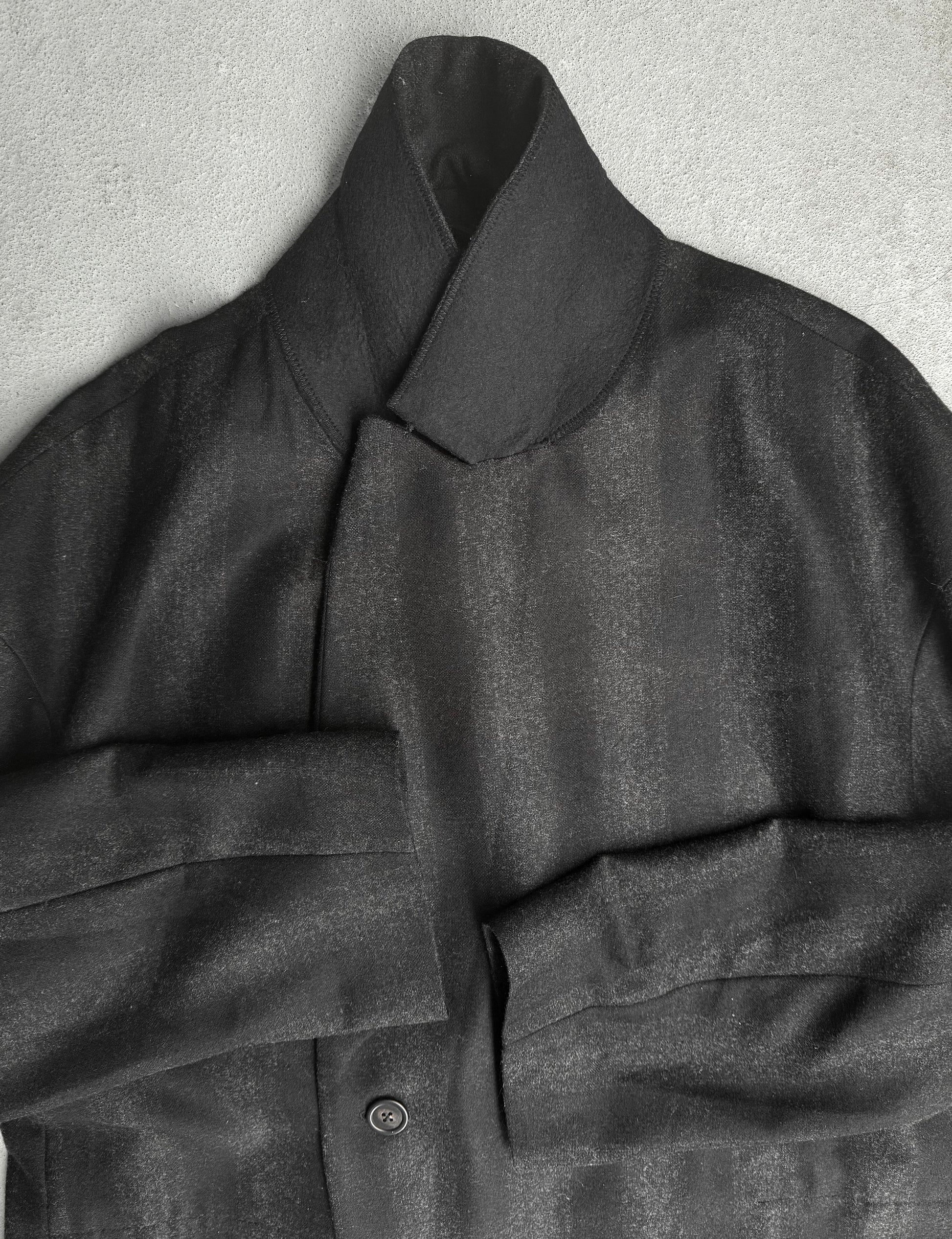 Dark gray coat with a collar on a light gray background