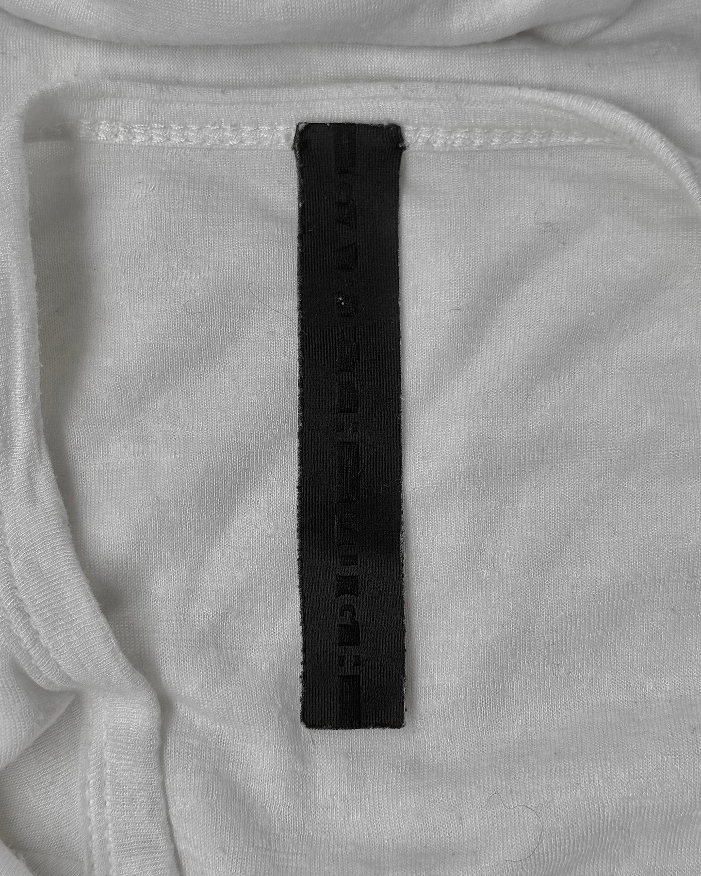 Close-up of a black label on gray fabric