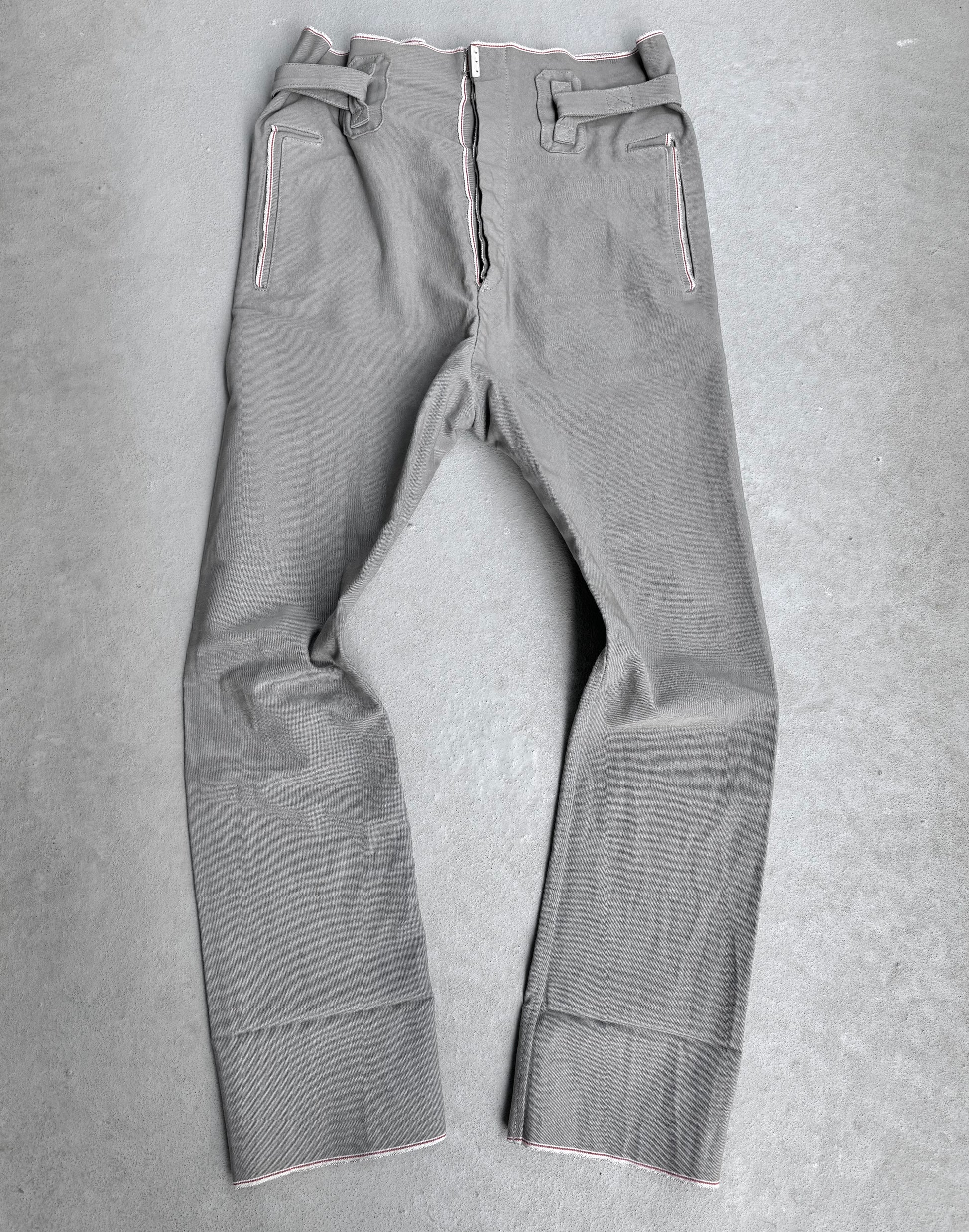 The Carol Christian Poell 2010 “IN-BETWEEN” PM/2578 PEDGE Self-edge High-waisted Metre Pants feature white stitching, a front zipper, belt loops, and two zippered pockets—exemplifying avant-garde materials and design from Carol Christian Poell.