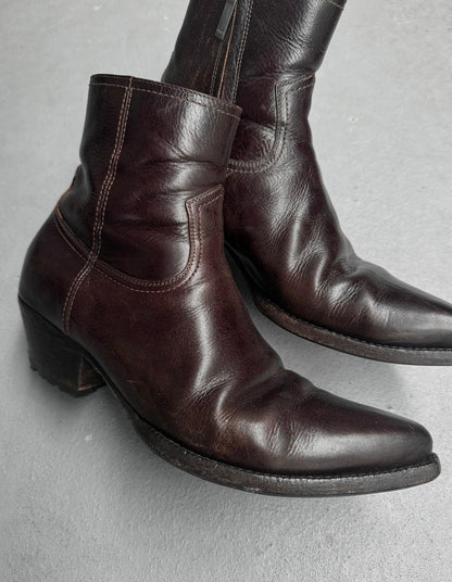 Pair of brown leather boots on a gray background